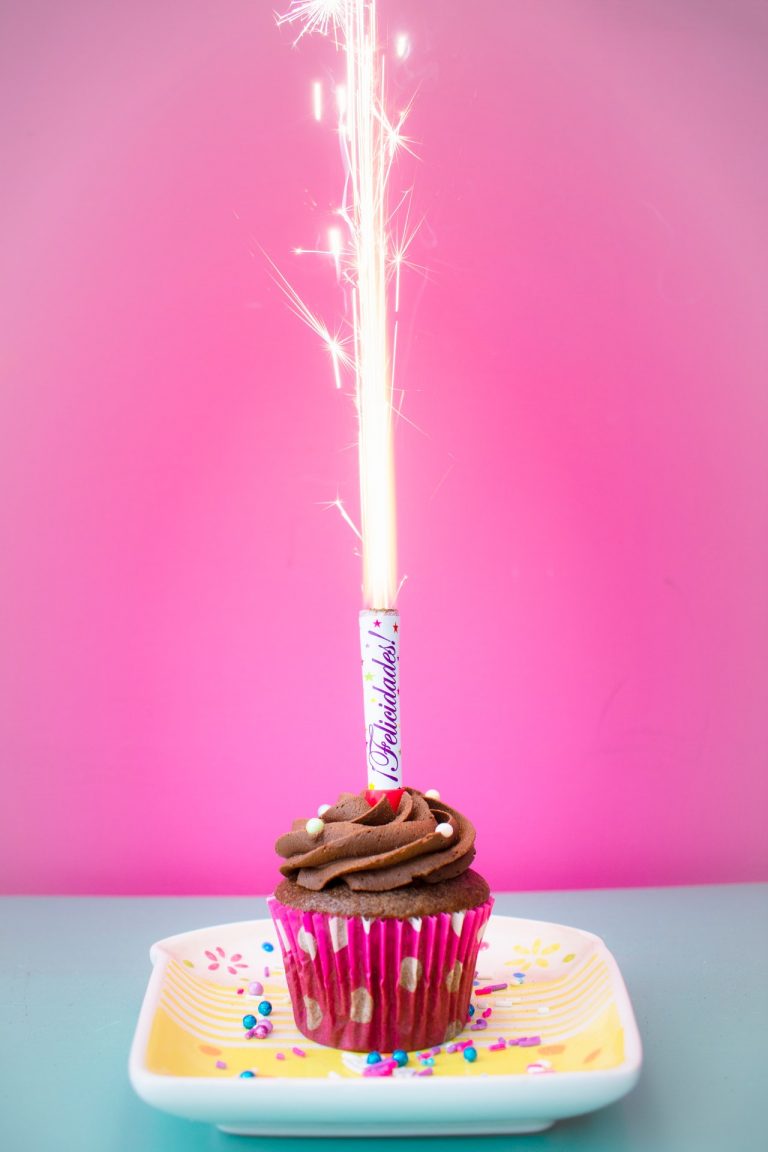 a cupcake with a candle on top of it
