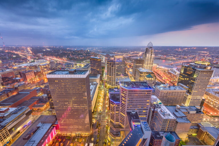 Cincinnati skyline at dusk showcasing urban architecture and city lights, relevant to real estate insights