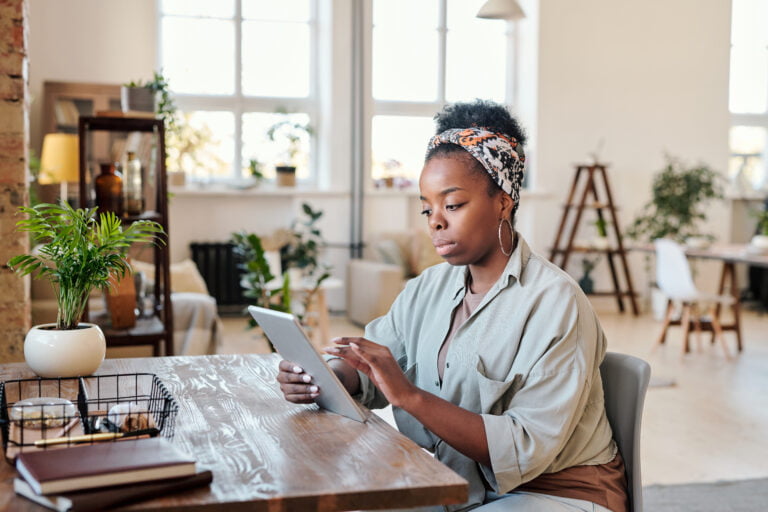 Person working on online project in open-space office, illustrating online background checks and information gathering.