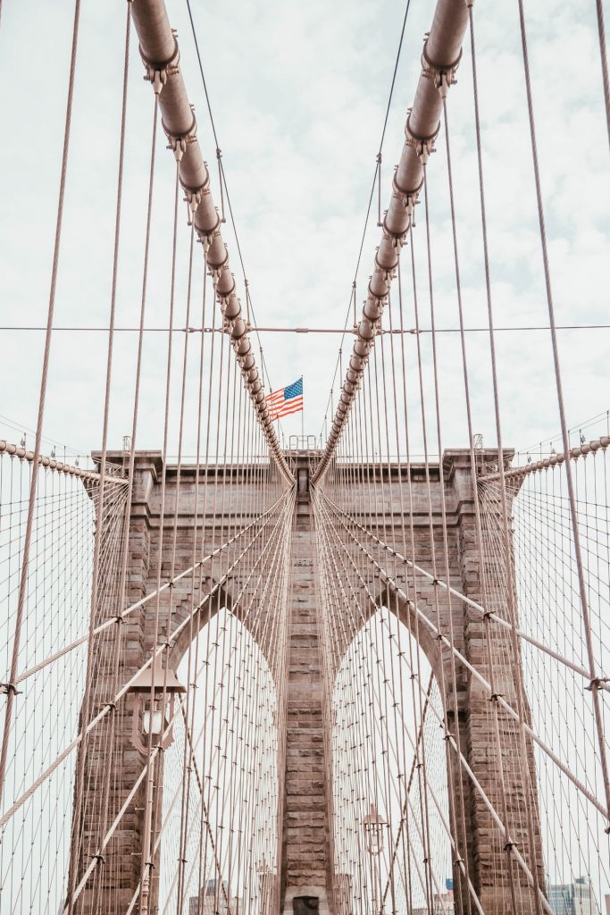 a tall bridge with a flag on it