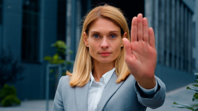 Woman gesturing stop hand illustrating personal boundaries